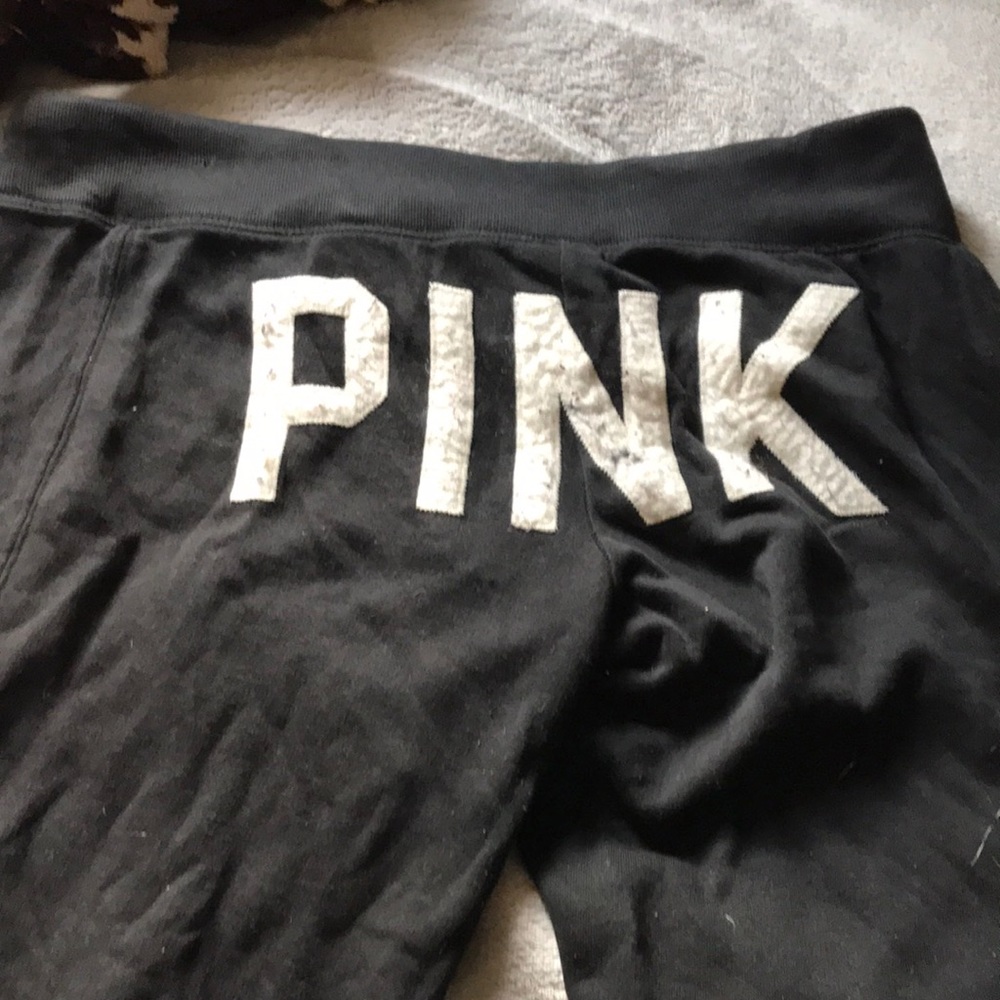 Black sweatpants with “PINK” on the butt.